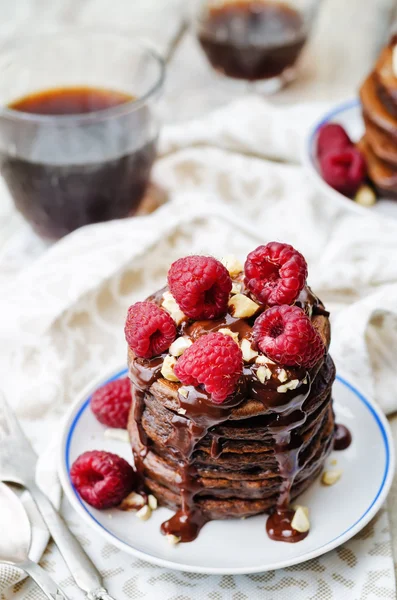 Chocolate pancake with bananas, raspberies, nuts and chocolate s