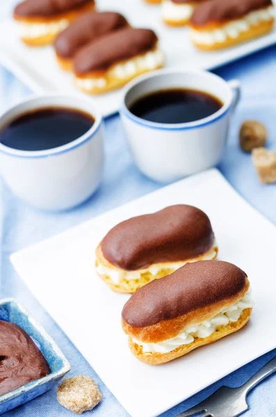 Eclairs with cheese cream and chocolate glaze