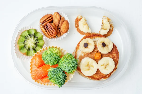 School lunch box for kids with food in the form of funny faces