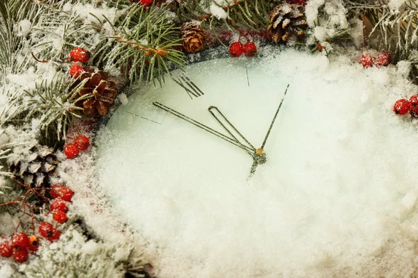 Large clock covered with snow before the new year