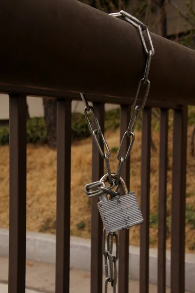 A metallic padlock lock with chain