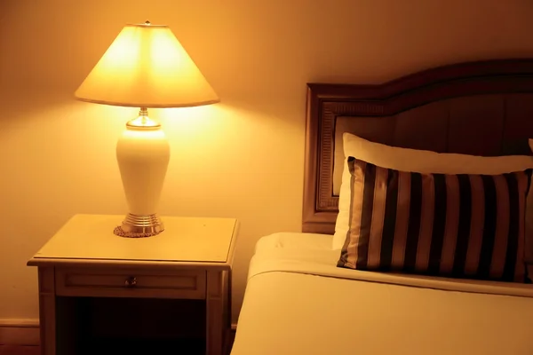 Night scene image of hotel room interior, comfortable bed, pillo