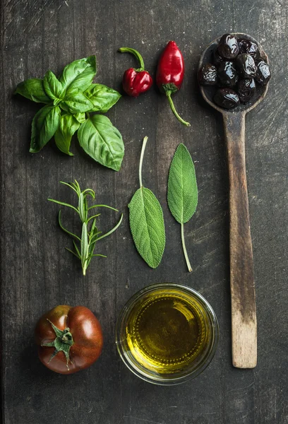 Vegetables and herbs on dark wooden background