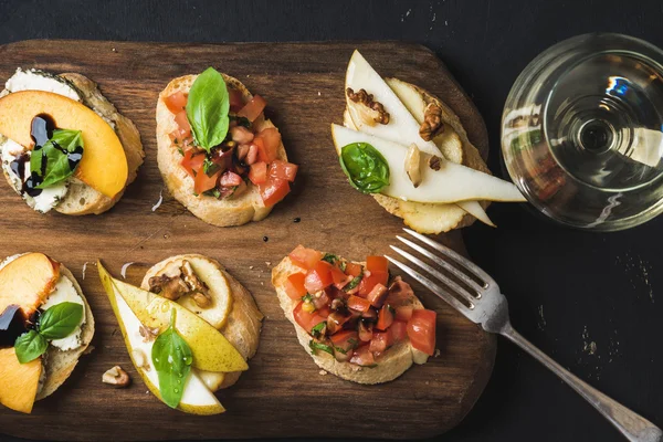 Bruschetta set with glass of white wine