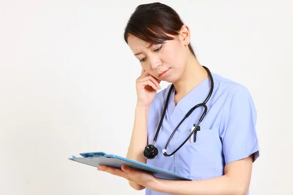 Young Japanese female doctor worries about something　
