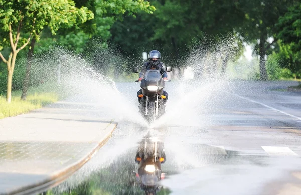 Rider goes to the puddle with splashes