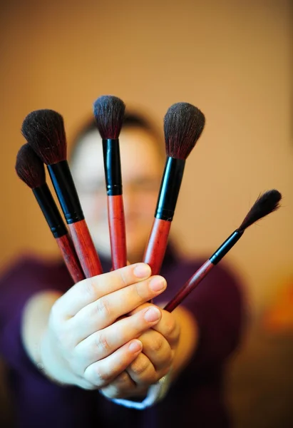 Brushes for makeup in hands