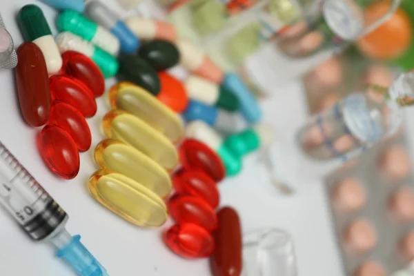 Red and white pill capsules pile