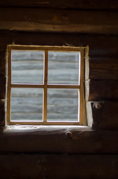 Bright square window inside the loghouse