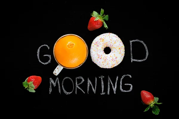 Good morning greeting on chalk board. Healthy food, fresh fruits and donut