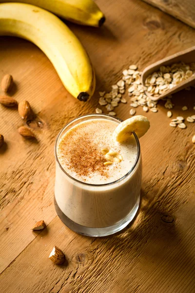 Banana smoothie with cinnamon, peanut butter and oat flakes. Healthy vegan breakfast