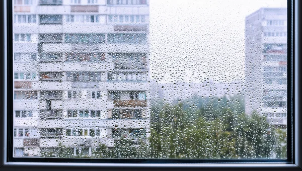 Rainy window with view on the city