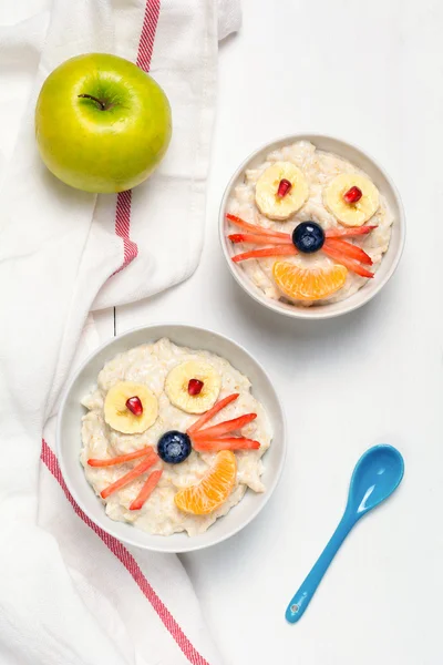 Oatmeal porridge, healthy breakfast for kids. Funny food for children