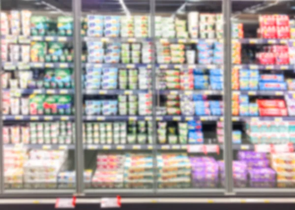 Blurred supermarket background full of products in row