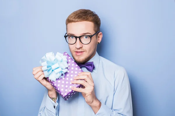 Young man with a wrapped gift box. Present, birthday, Valentine
