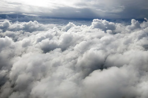 The wing of the Airbus above the clouds in the sky.