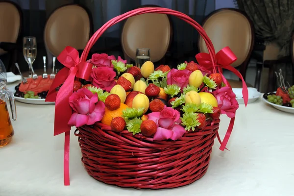 Wicker basket with mix fruits and flowers