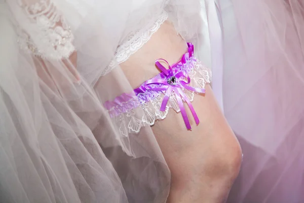 Wedding garter on leg of bride.
