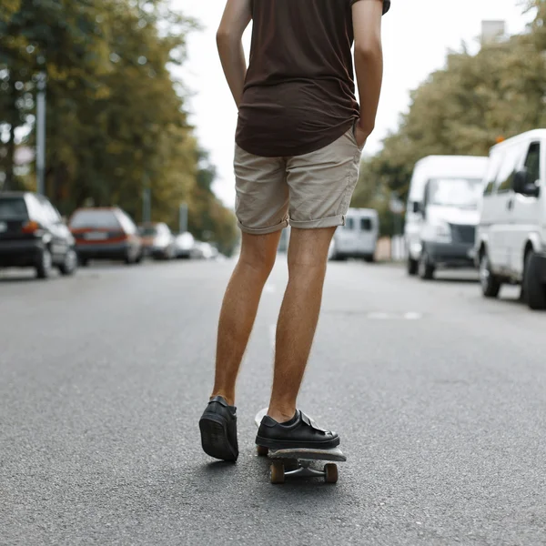 Man riding on a skateboard. Legs on a skateboard.