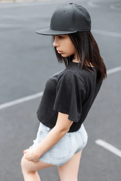 Young stylish girl in a black baseball cap