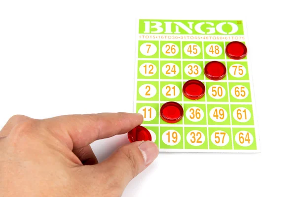 Hand putting last chip to be winner of bingo game