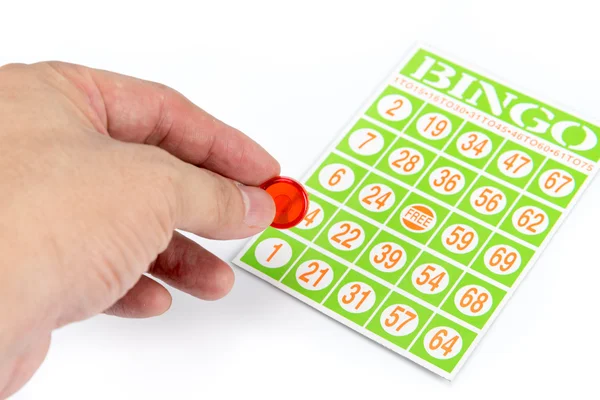 Hand putting first chip to bingo game card