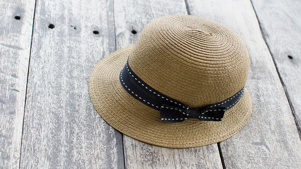 Vintage woman hat or woman beach hat on wooden floor