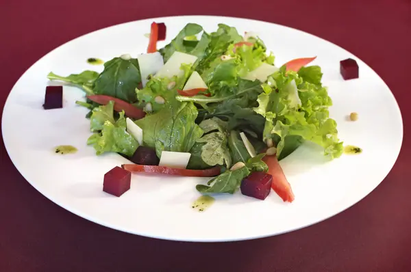Vegetarian bright salad with beet and ruccola leaves