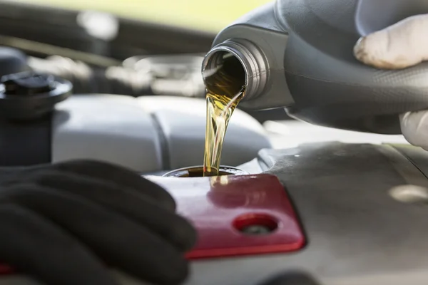 Fresh oil being poured into a car