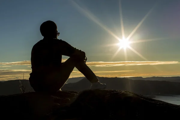 Silhouette man on a mountain top
