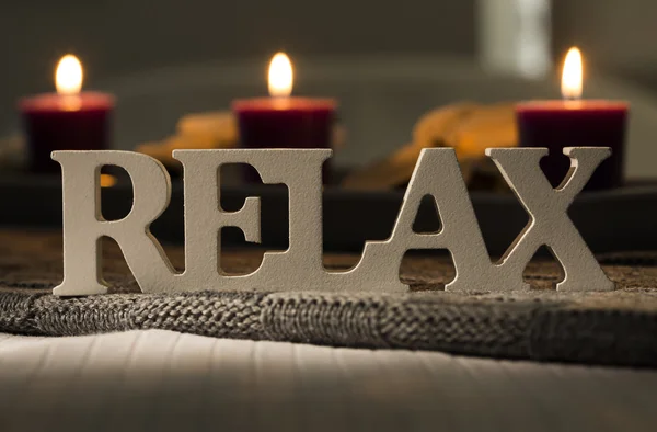 Text of the words relax with burning candles