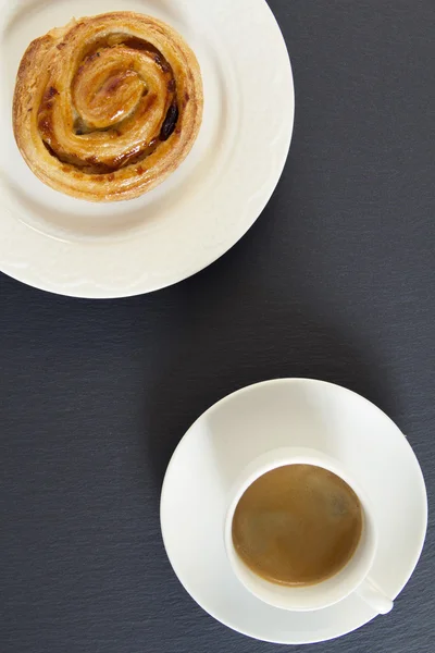 Breakfast: a coffee and a danish puff pastry swirl.