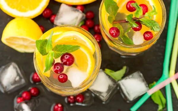 Lemonade - a refreshing drink made of citrus and berries with mint and ice