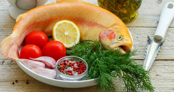 Amber trout. Fish for baking with vegetables and spices - tomatoes, garlic, lemon, dill, sea salt, pepper. Healthy food or diet nutrition concept. Selective focus