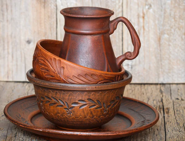 A set of homemade brown pottery for kitchen. Brown clay. Utensils