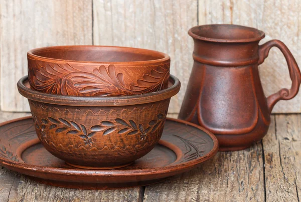 A set of homemade brown pottery for kitchen. Brown clay. Utensils