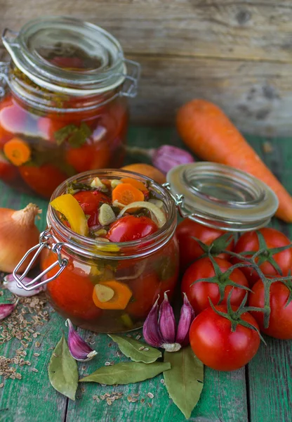 Open glass jar of tasty canned tomatoes