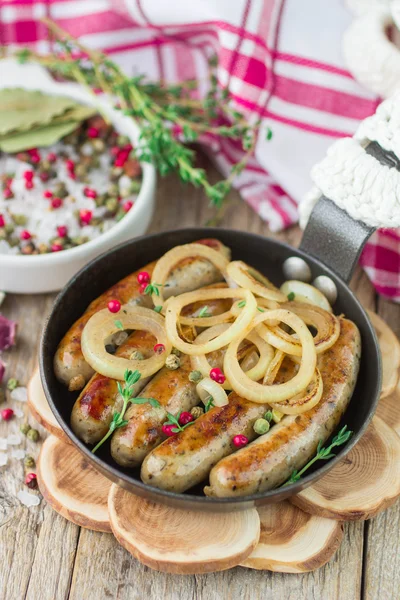 Fried sausages with spices and onions