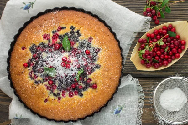 Sponge cake with berries - cranberries and blueberries