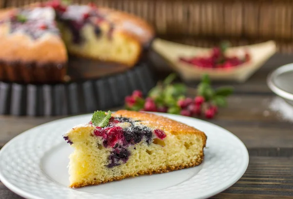 Sponge cake with berries - cranberries and blueberries. Rustic s