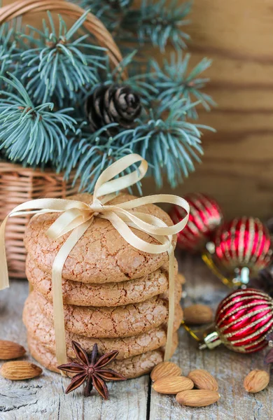 Spiced cookies with almonds. Christmas gifts. Round cookies, tied with ribbon and spruce branch in a basket on the table