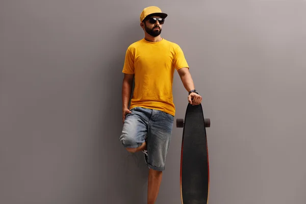 Male skater holding a longboard
