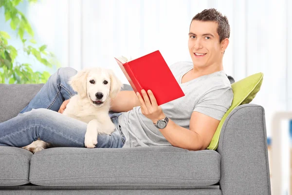 Man reading book with dog