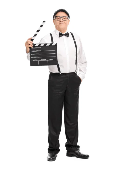 Mature movie director holding a clapperboard