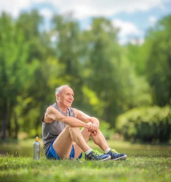 Senior man in sportswear sitting in a park