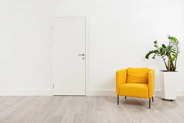 Waiting room with a yellow armchair