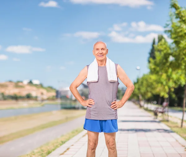 Senior man in sportswear standing on a sidewalk