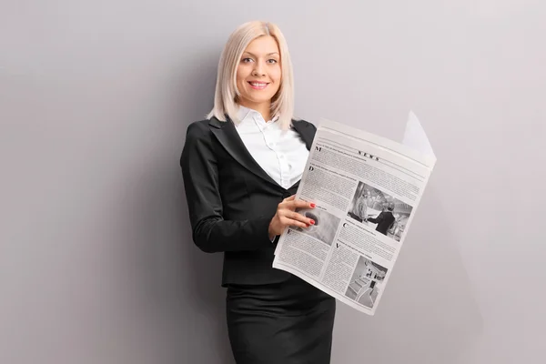 Businesswoman holding a newspaper