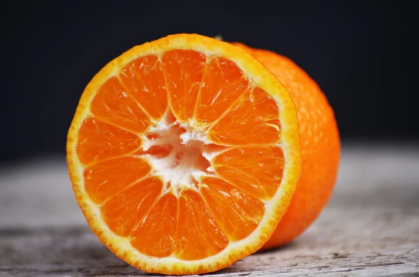 Fresh sliced mandarin on wooden table. Top view.