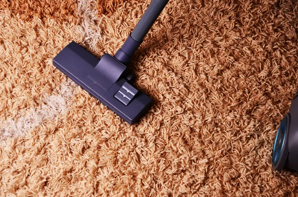 Vacuum cleaner on the carpet. Modern living room, with a vacuum cleaner to tidy up